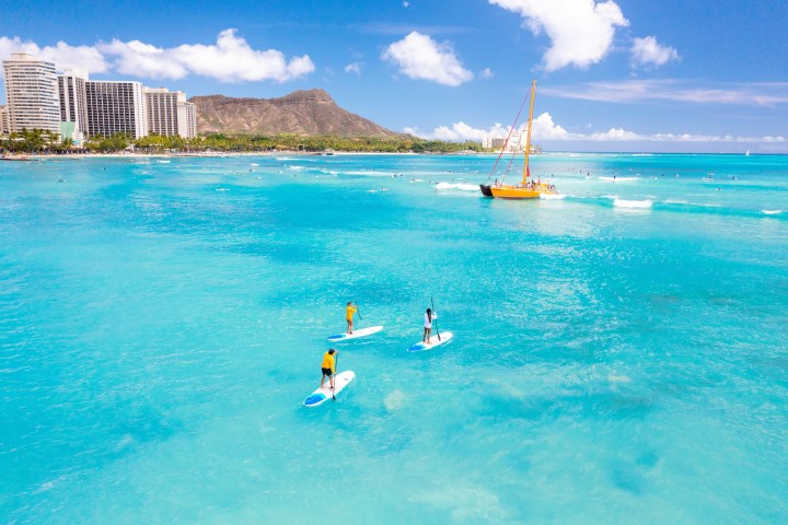 a person riding a wave on top of a body of water