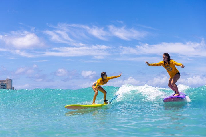 a man riding a wave on a surfboard in the water